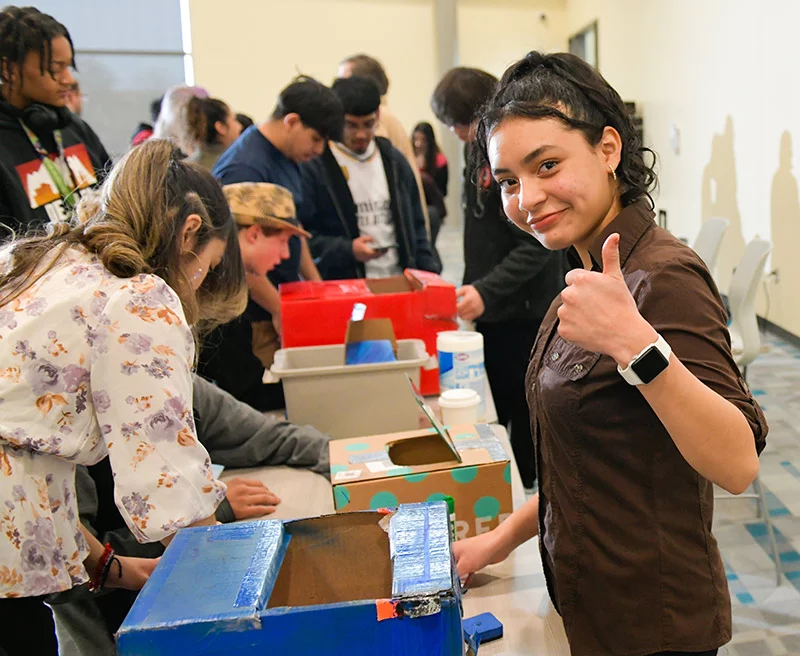 Tenth grader, Kelly Nava, gives a thumbs up as she participates in a hands-on neuroscience experiment at her school. The daughter of immigrants from Mexico, Kelly wants to become a surgeon someday. She loves going to school on a medical campus and learning about future career opportunities. Photo by Cyrus McCrimmon, for UCHealth.