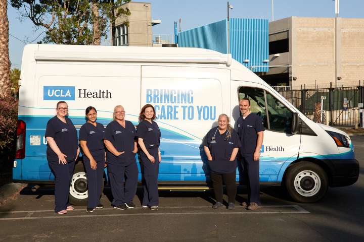 Members of Homeless Healthcare Collaborative stand in front of their van